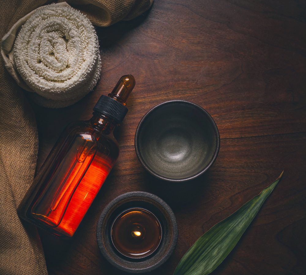 Warm oils, towels and candle detail at Soma Massage